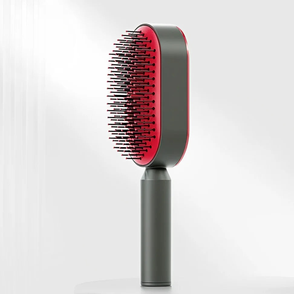 Minimalistische selbstreinigende Haarbürste in Schwarz-Rot mit ergonomischem Griff und flexiblen Borsten – modernes Beauty-Tool zum schmerzfreien Entwirren und täglichen Styling für alle Haartypen.