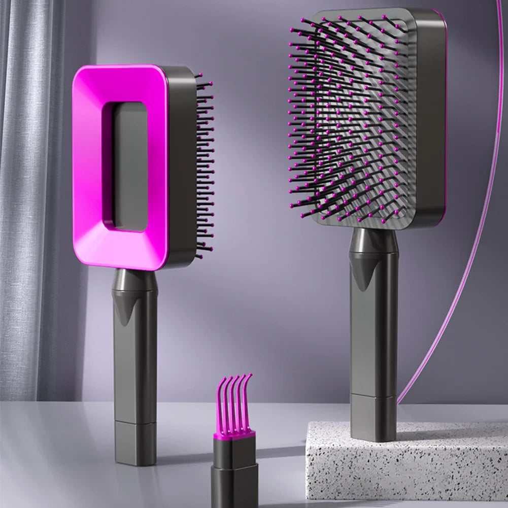 Selbstreinigende Massage-Haarbürsten in Dunkelgrau mit pinkem Akzent – manuelle Entwirrungsbürsten mit ergonomischem Griff und integrierten Reinigungsbürstchen im Griff, ideal für sanfte Kopfhautmassage und schonende Haarpflege ohne Ziepen.