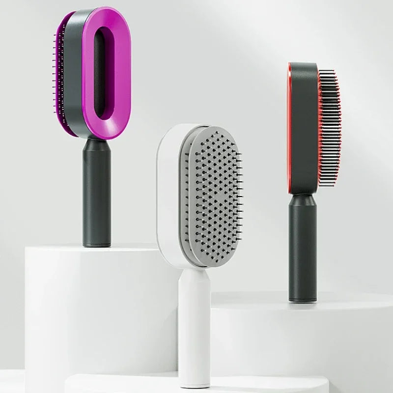 Moderne selbstreinigende Haarbürsten in verschiedenen Farben – pink, weiß und rot – mit innovativem Design für schonendes Entwirren und Haarpflege. Stylische Detangler-Bürsten für glattes Haar ohne Ziepen.